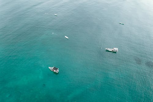 Boats sailing in picturesque ocean on sunny day