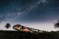 Crashed airplane on land under bright sky in evening