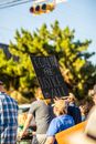 Back view of unrecognizable group of protesters showing placard with BLM title in demonstration on street