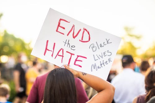 Faceless social justice warriors showing BLM title on placard