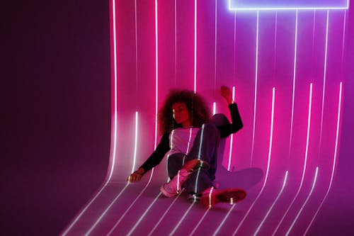 Woman in Black Shirt and Red Pants Sitting on Floor