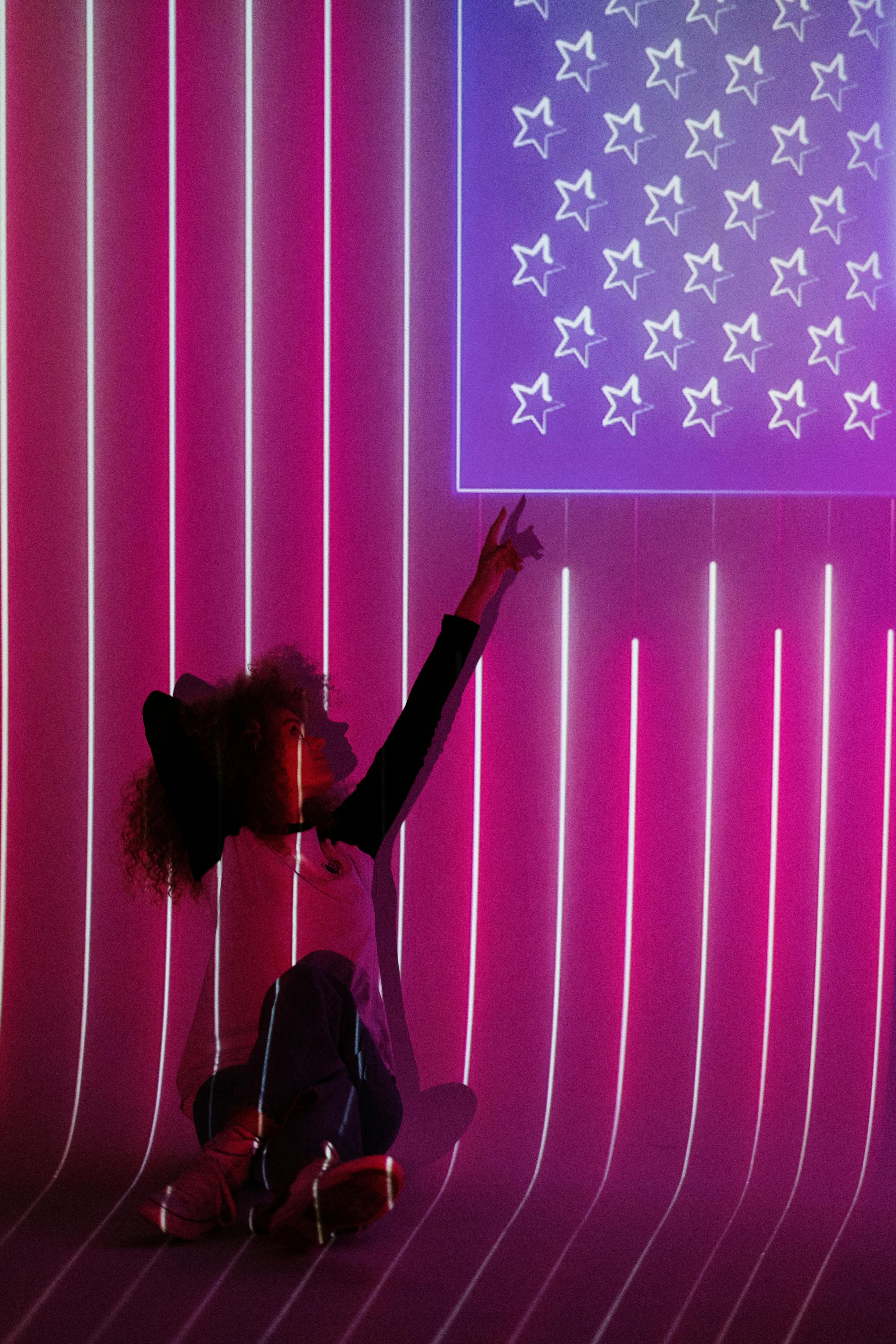 woman in front of a projection of the american flag