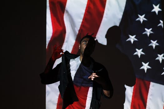 Dramatic portrait of a man with American flag projected, symbolizing patriotism.