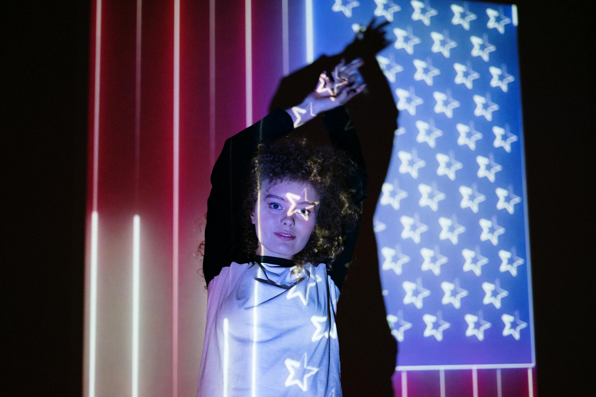 Une femme devant une projection du drapeau américain