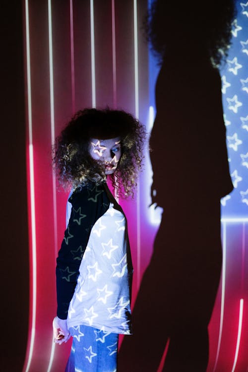 Woman Standing in Front of a Projection of the American Flag