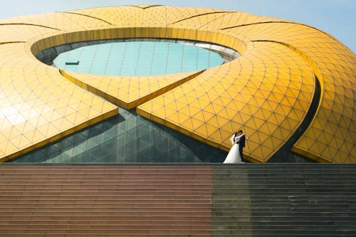 Newlywed Couple Kissing in Lam Vien Square Dalat Building