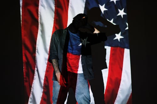 Man Standing in Front of a Projection of the American Flag