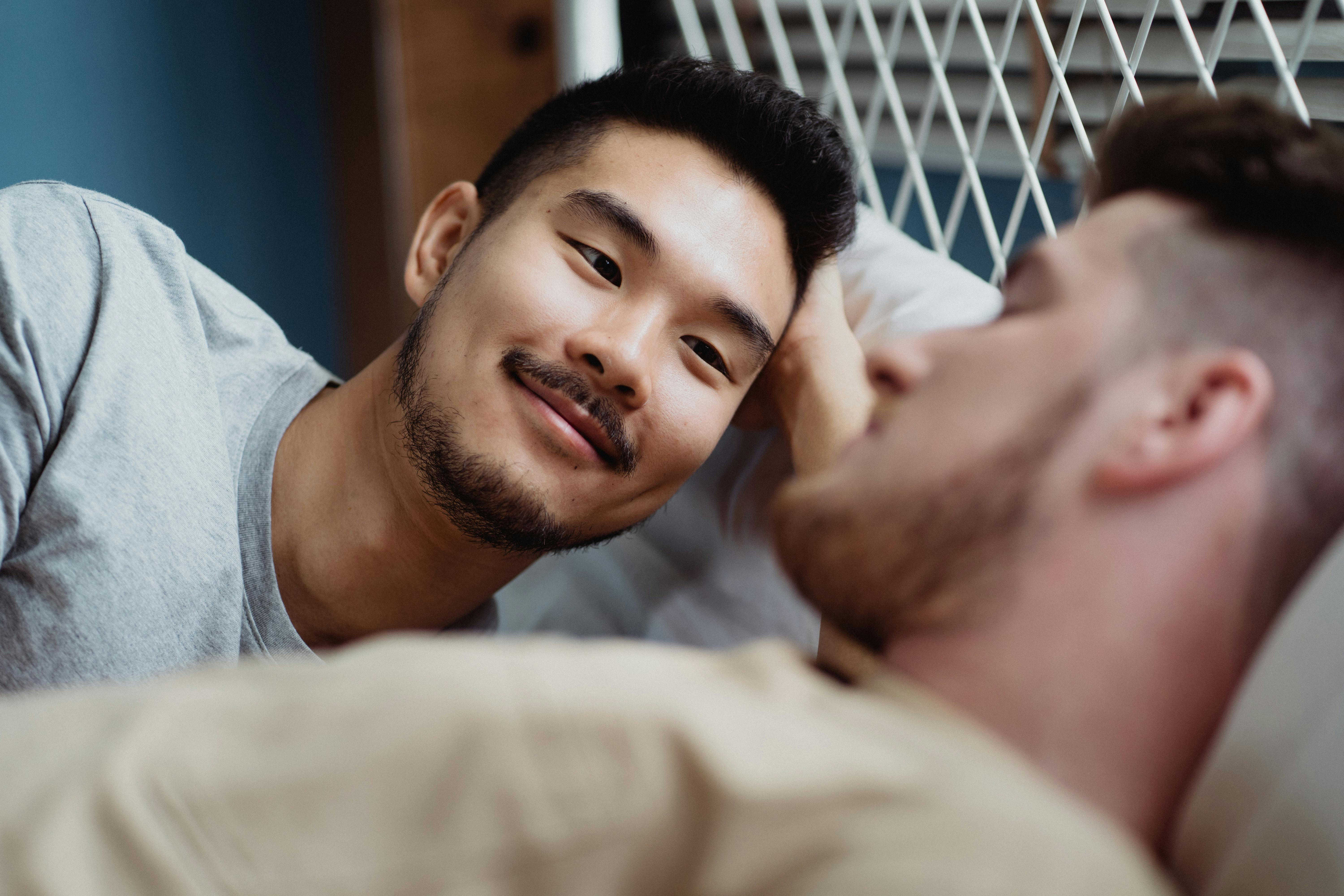 man looking at another man sleeping