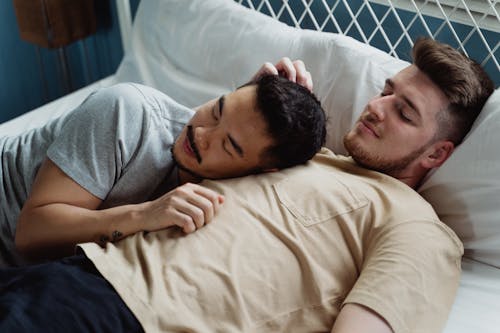 Free Male Couple Lying on Bed Stock Photo