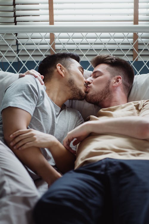 Free Two Men Kissing in Bed Stock Photo
