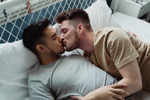 Two Men Kissing in Bed