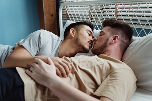 Free Two Men Kissing in Bed Stock Photo