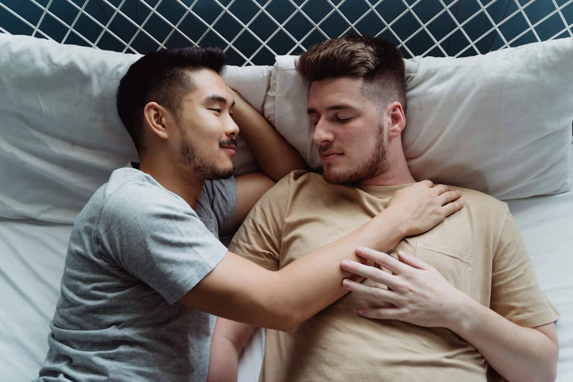 Two Men Lying Together in Bed