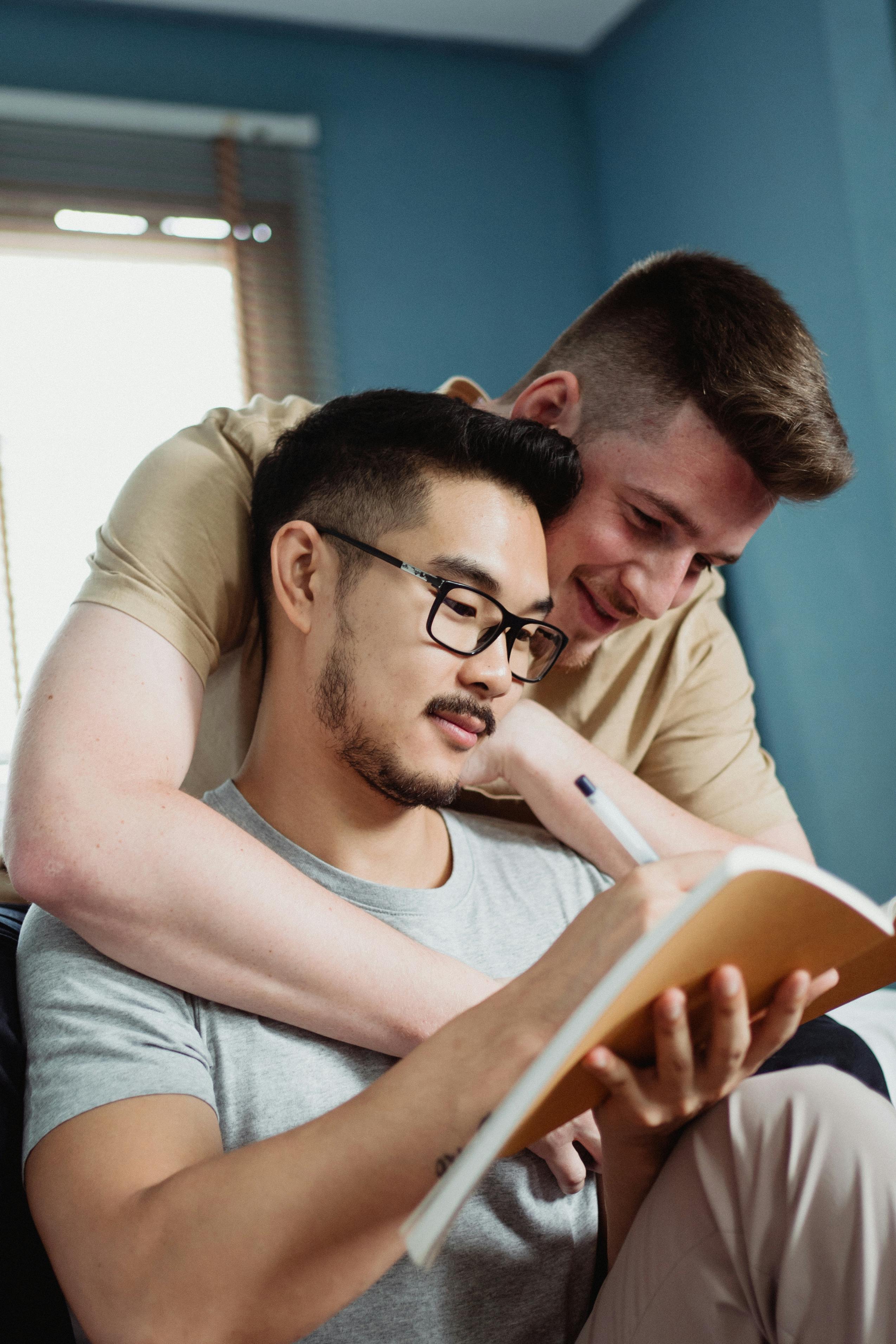 two men reading a book