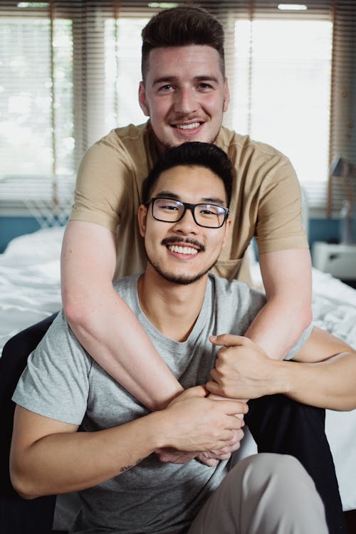 Free Two Men Being Affectionate and Looking at the Camera Stock Photo