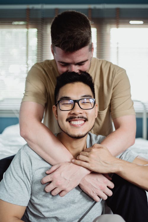 Free Man Being Embraced by Another Man Stock Photo