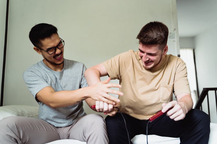 Men Playing Video Games And Play Fighting