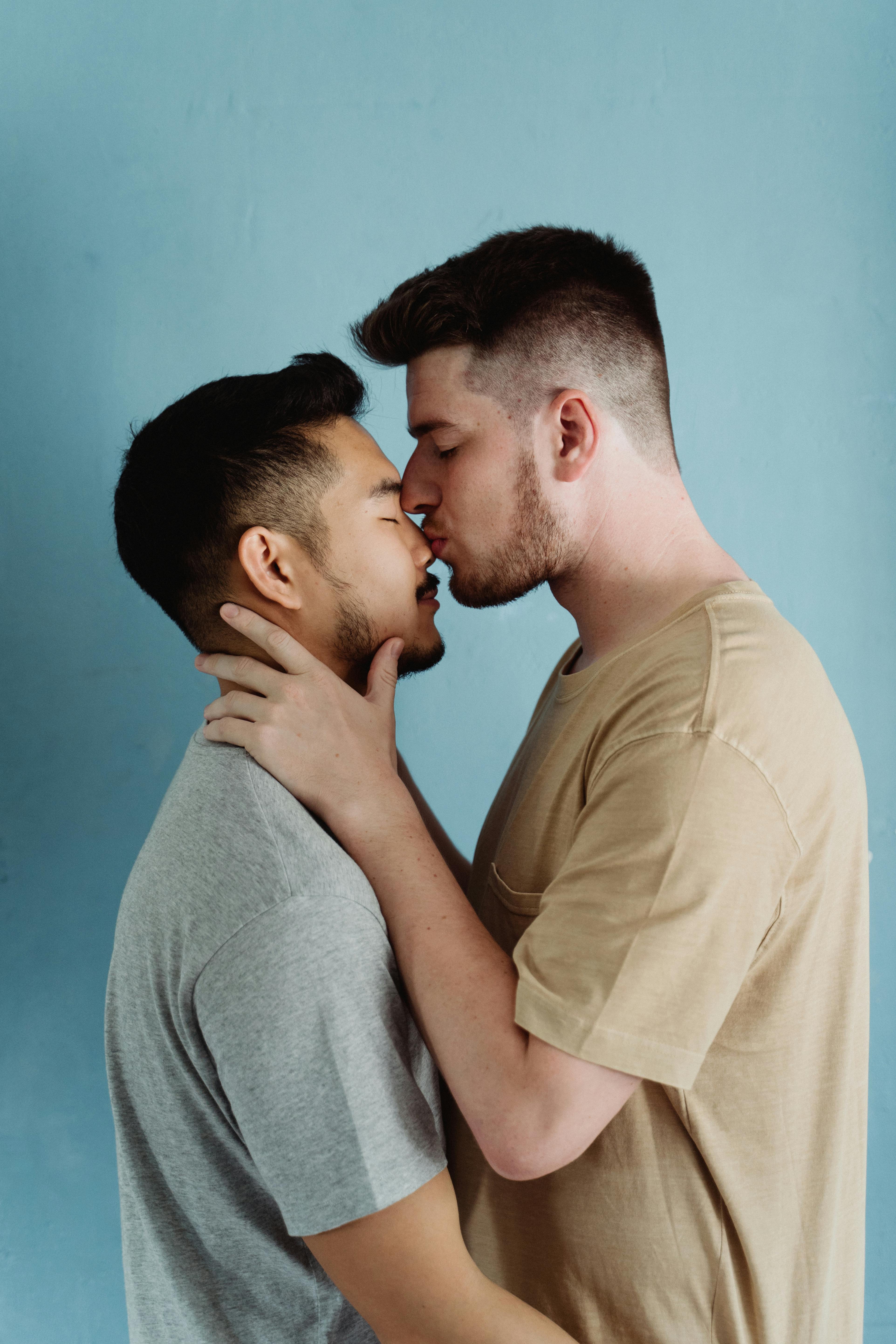 man kissing another man on the nose