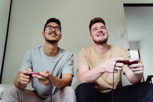 Two men happily playing video games in a modern living room.