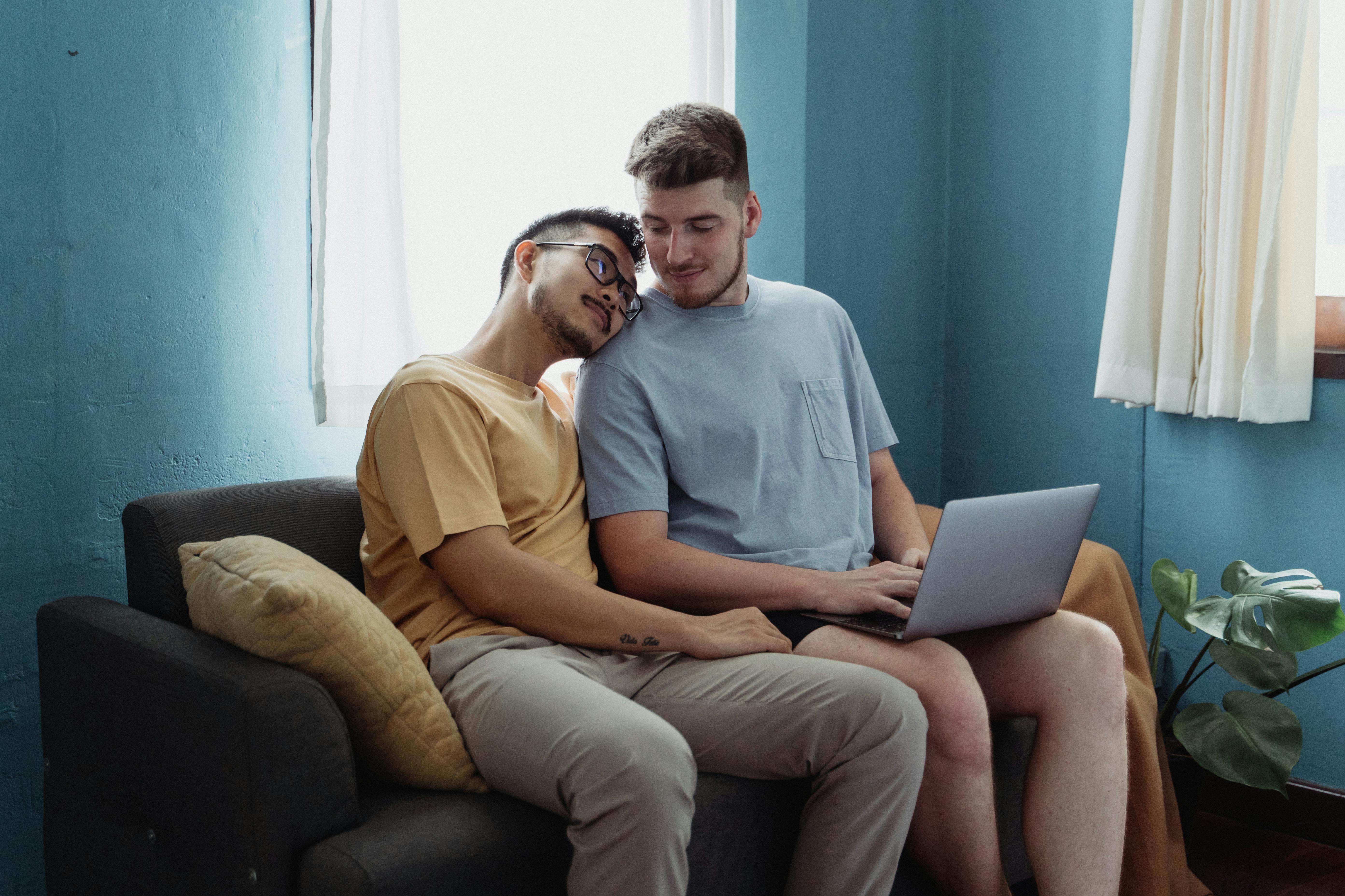 man resting his head on another man s shoulder