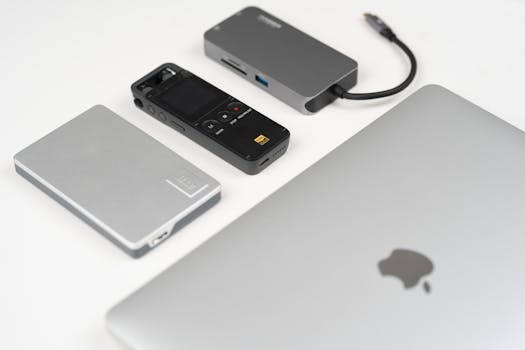 A collection of sleek tech gadgets on a minimalist desk, showcasing modern technology.