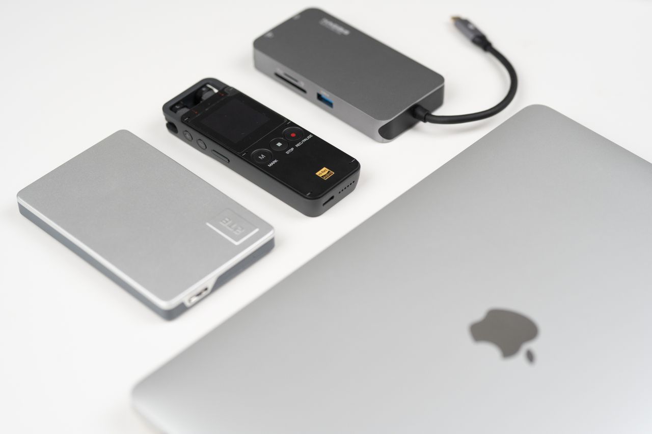 A collection of sleek tech gadgets on a minimalist desk, showcasing modern technology.