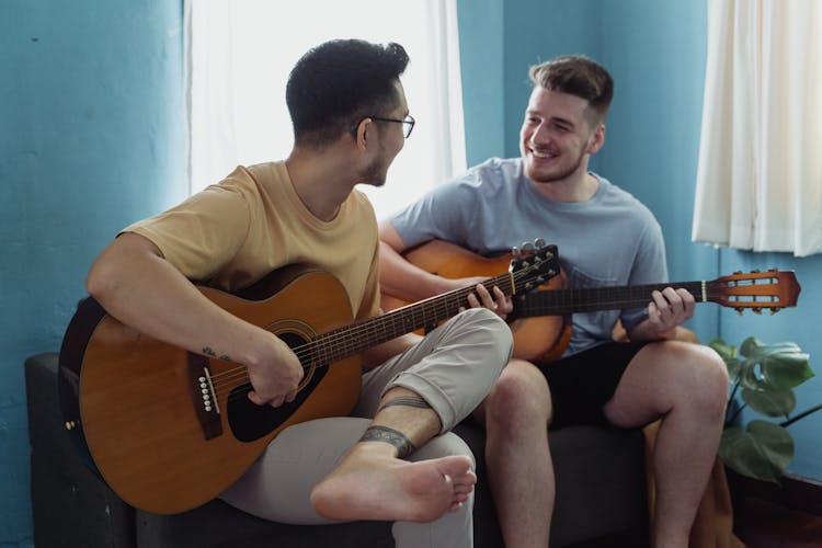 Men Playing Guitars Together