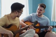 Man in White Crew Neck T-shirt Playing Brown Acoustic Guitar