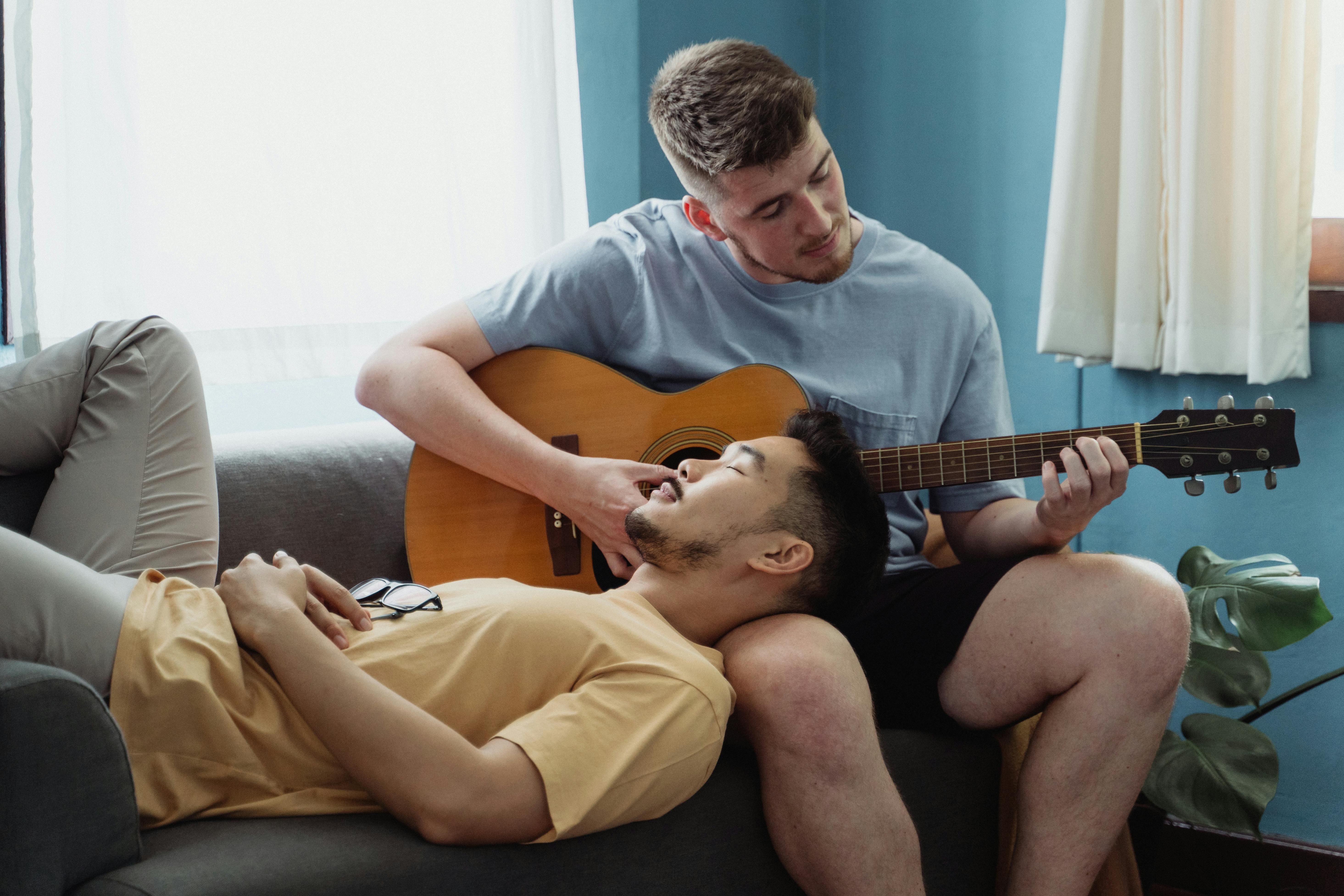 two men relaxing on a couch