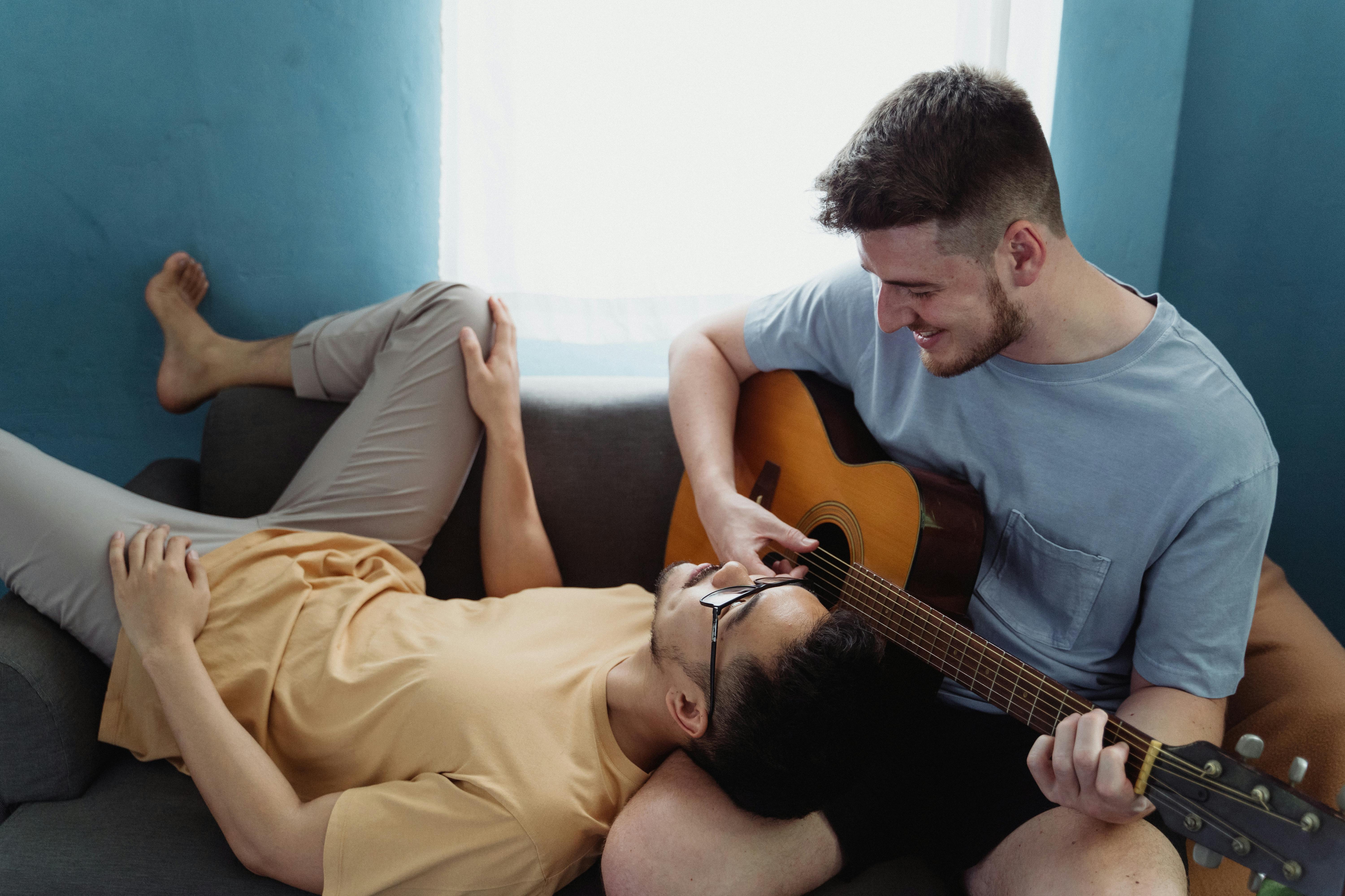 two men relaxing on a sofa