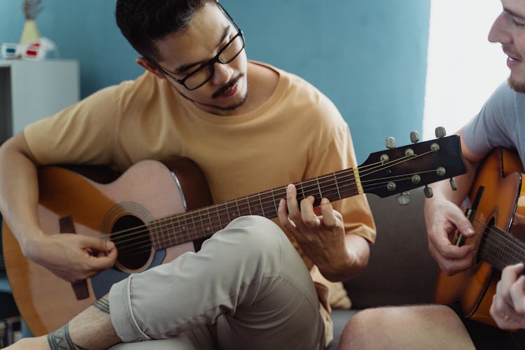 Men Playing The Guitars