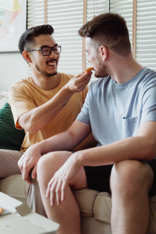 Free Man Feeding Another Man Stock Photo