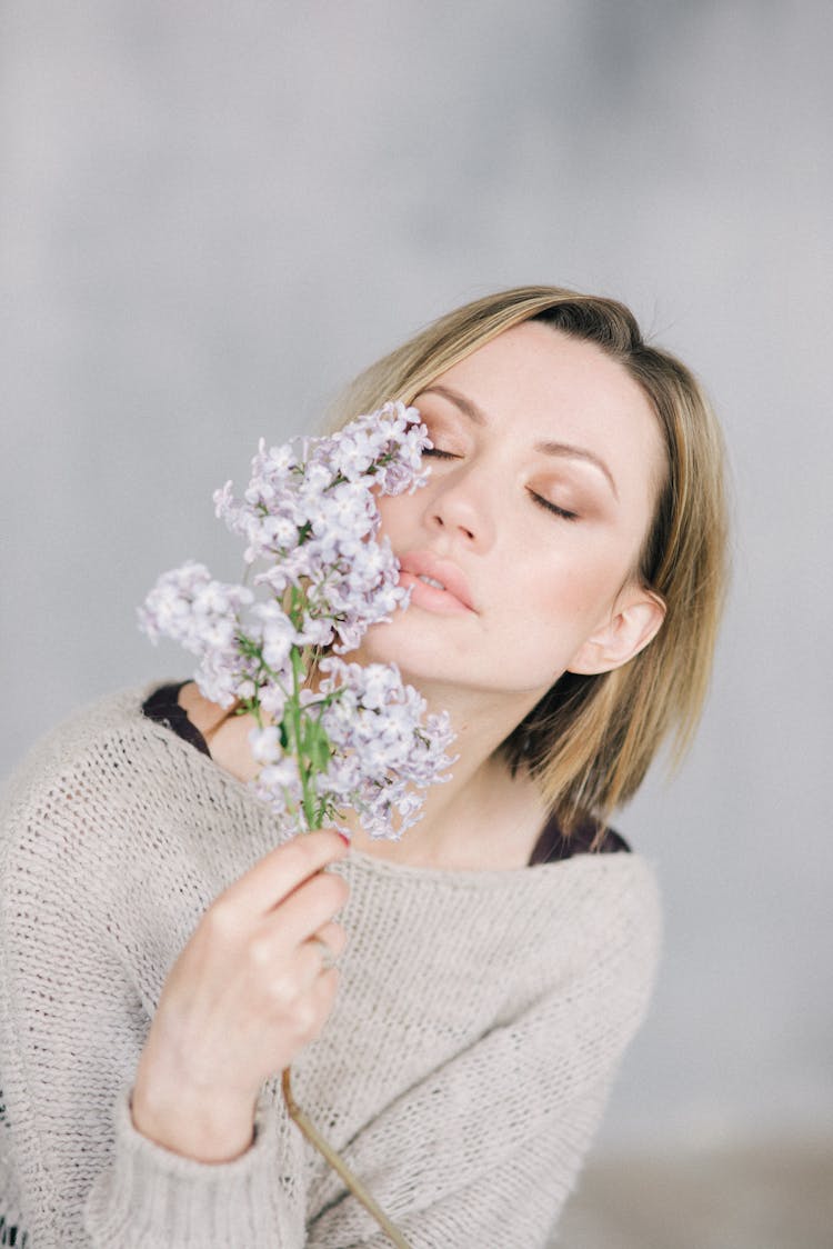 Woman Smelling Lilac Flowers