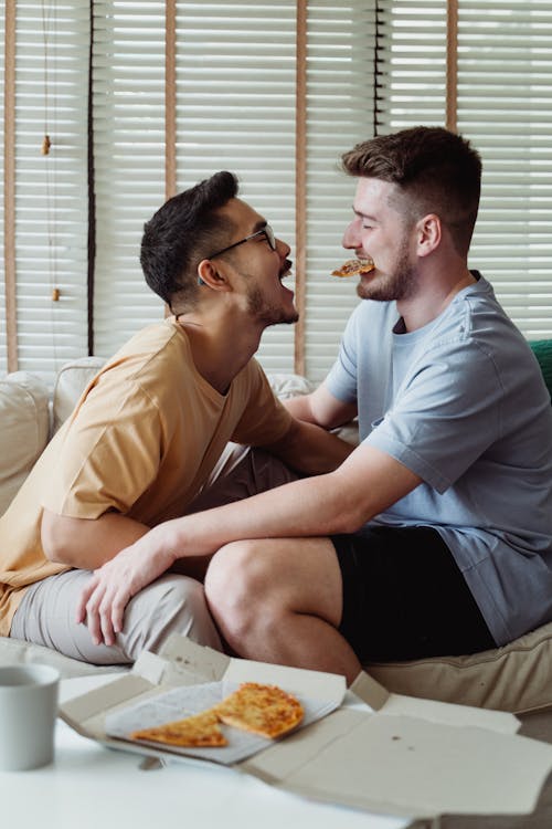 Two Men Sharing Pizza