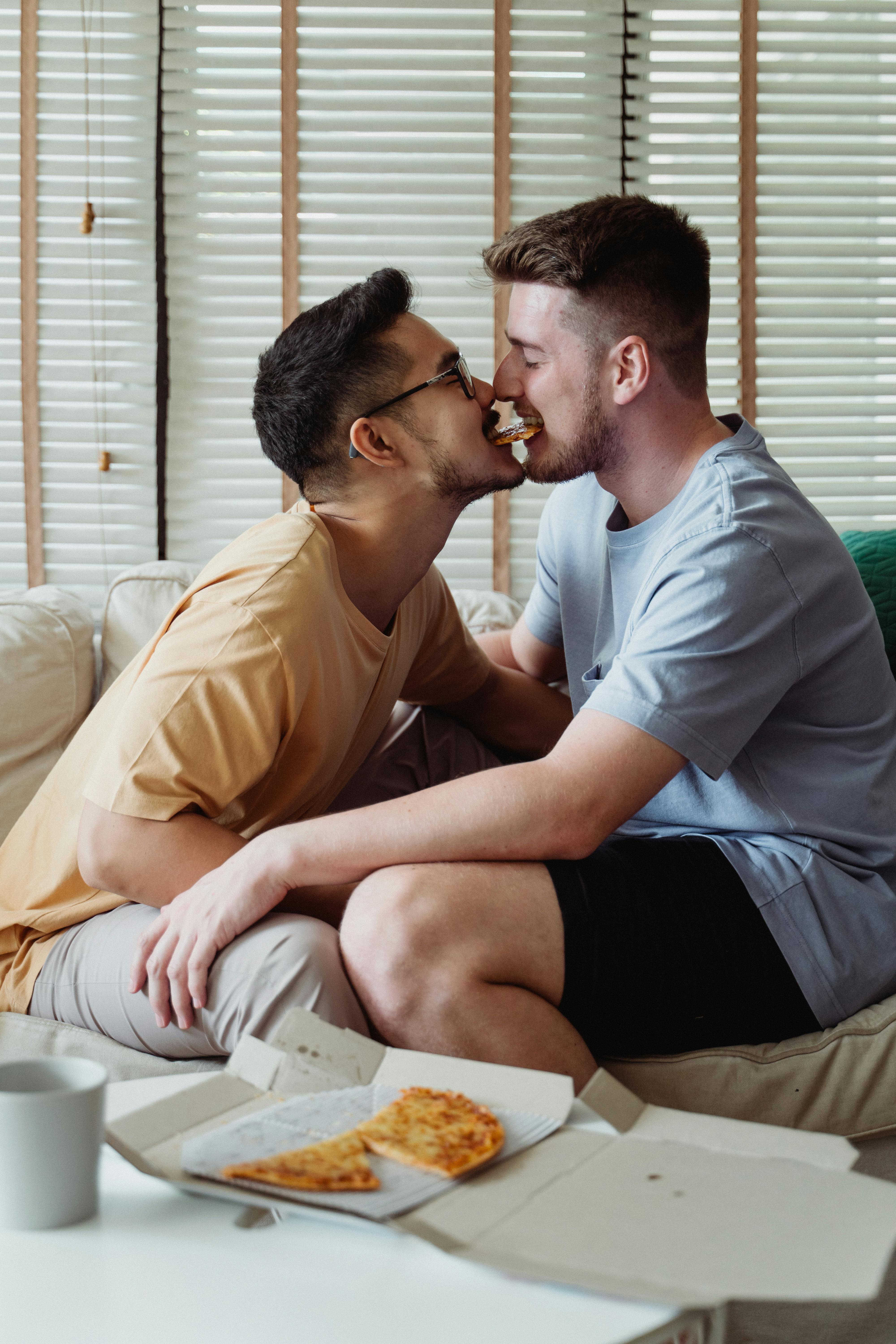 two men sharing sharing pizza