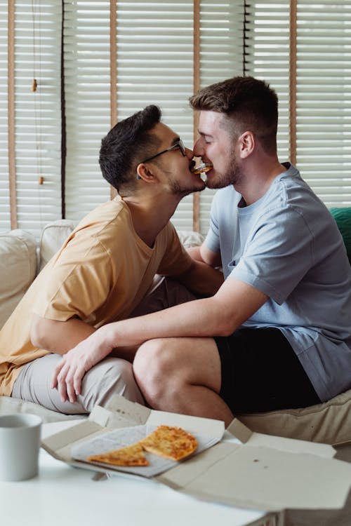 Free Two Men Sharing Sharing Pizza Stock Photo