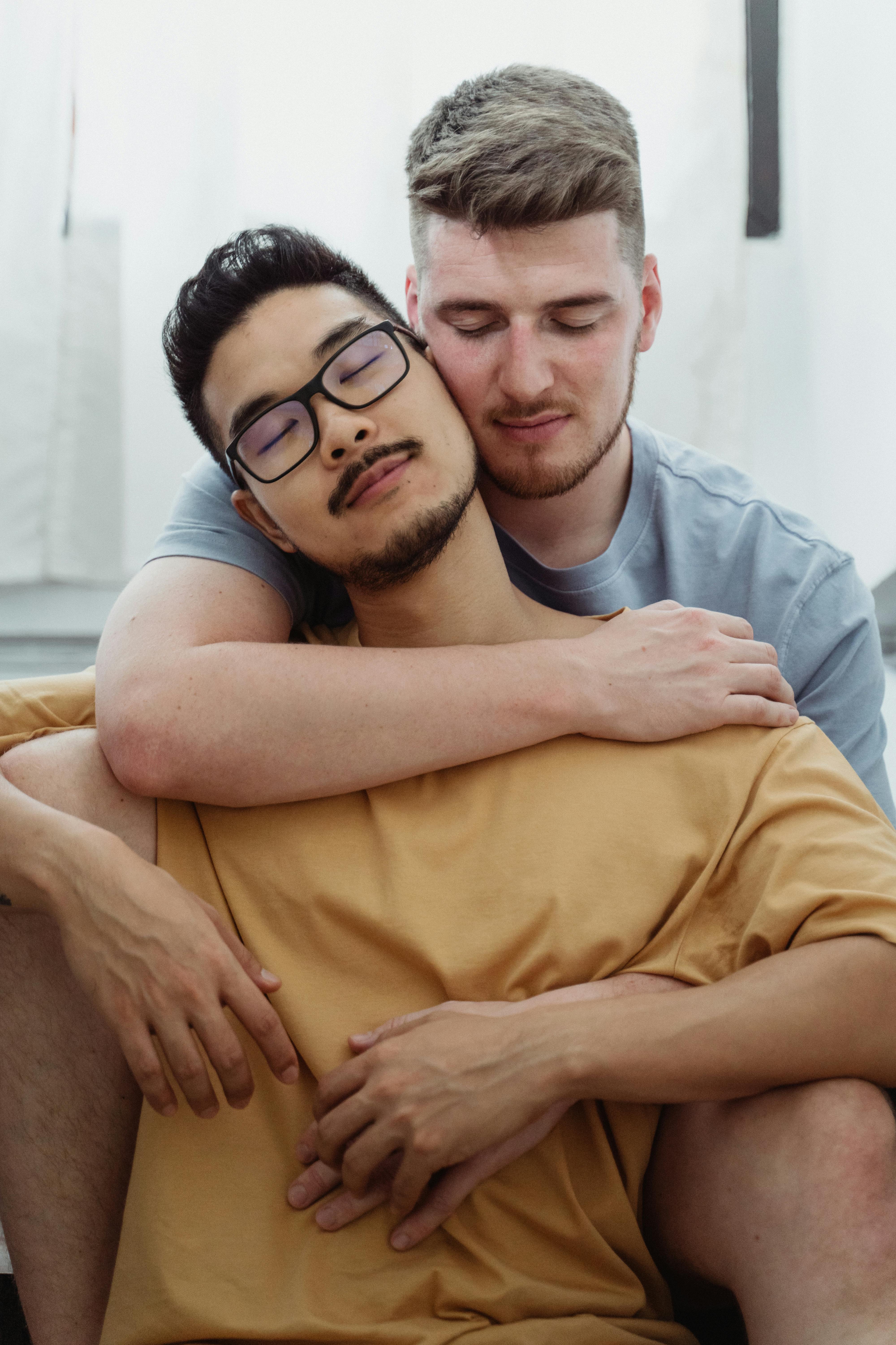 man being embraced by another man