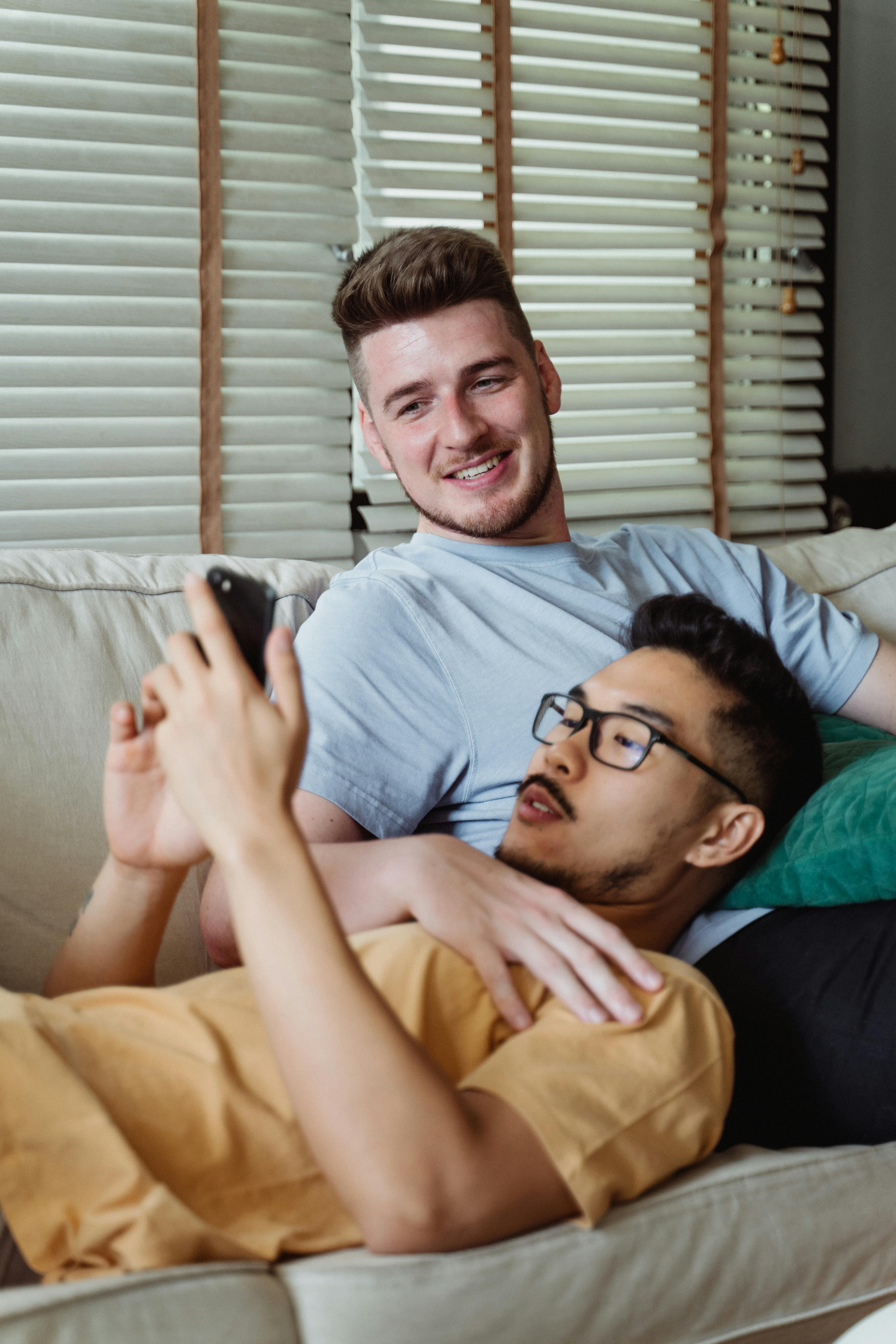 two men relaxing on a couch