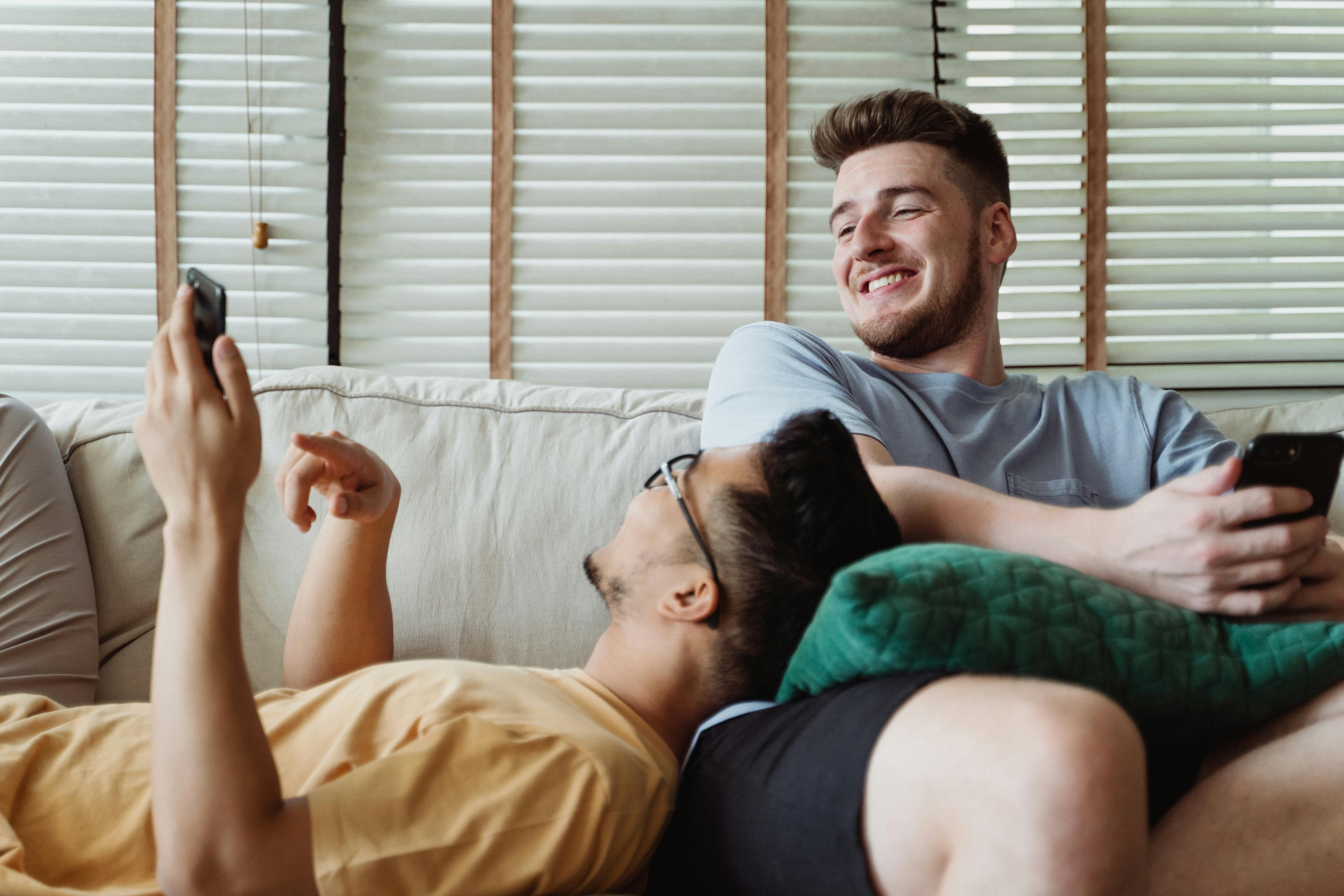 man showing a smartphone to another man