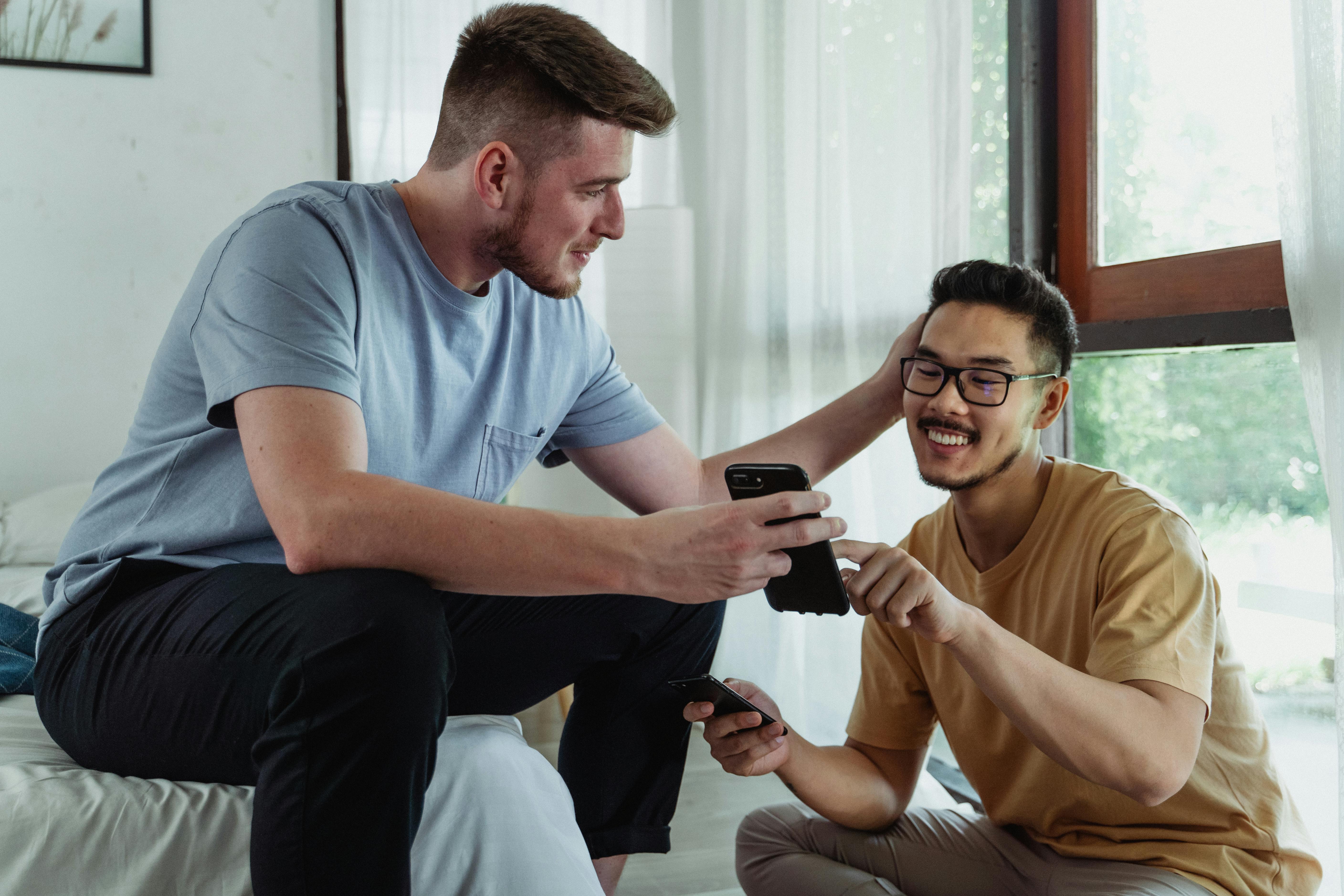 man showing a smartphone to another man