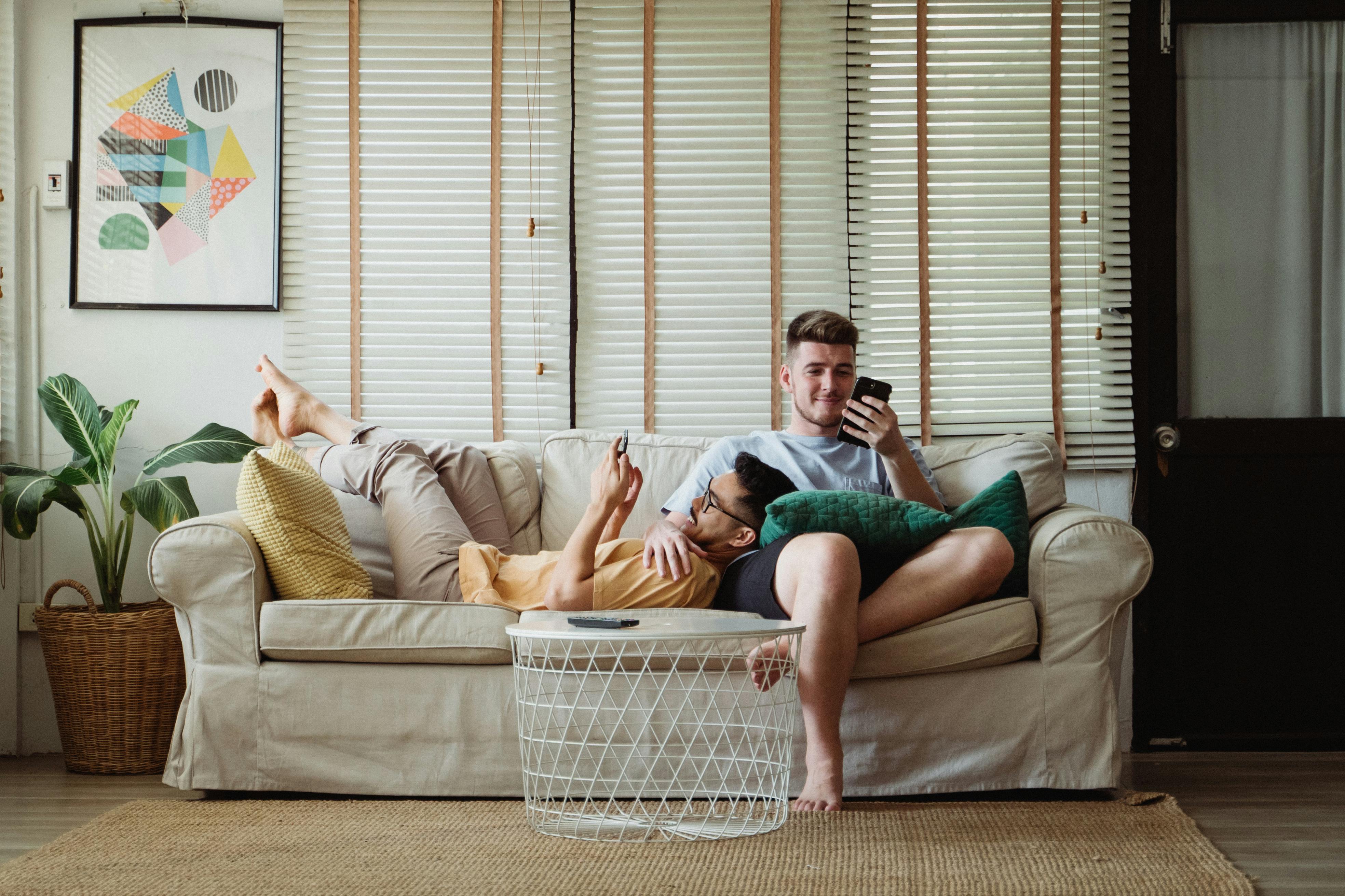 two men relaxing on a couch