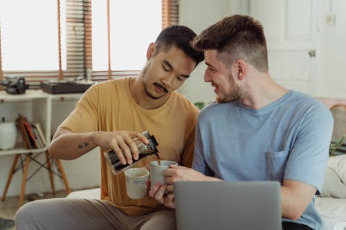 Man Serving Coffee to Another Man