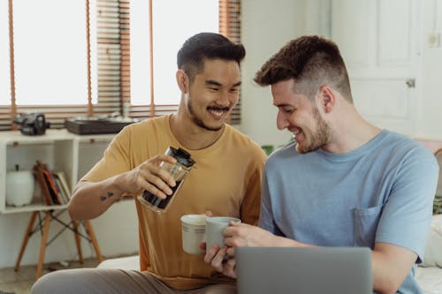 Man Serving Coffee to Another Man