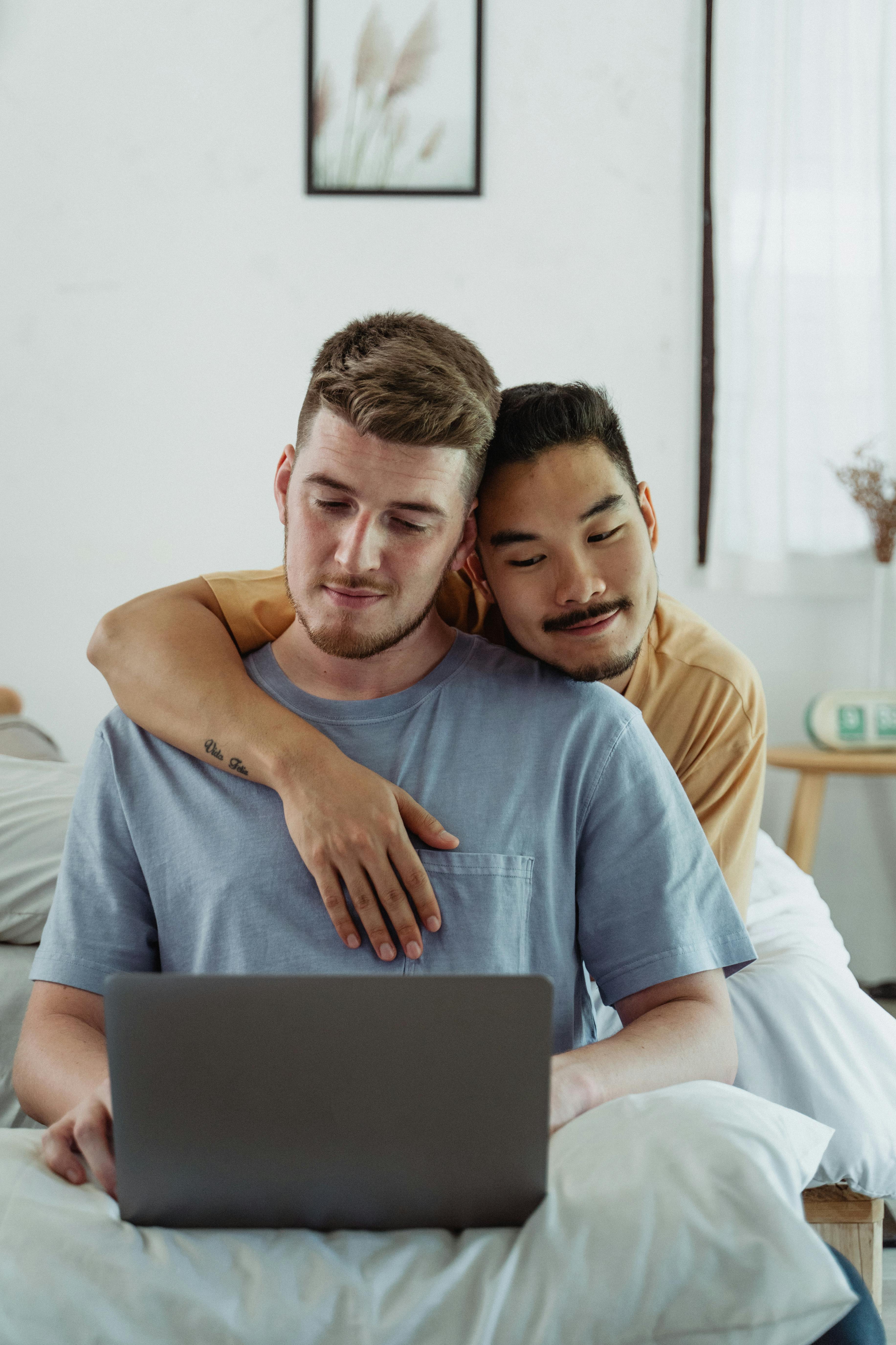 two men looking at a laptop