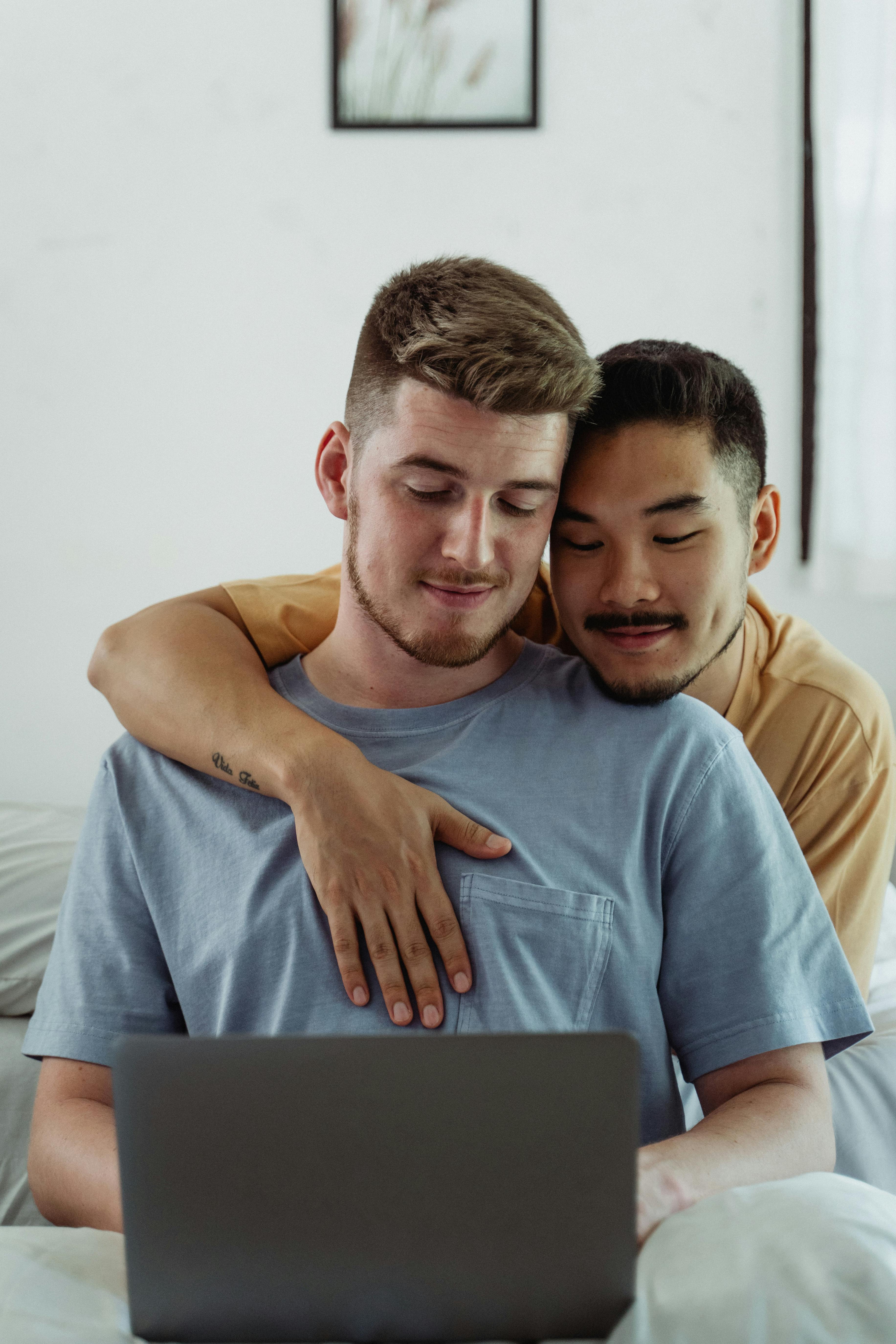 two men looking at a laptop