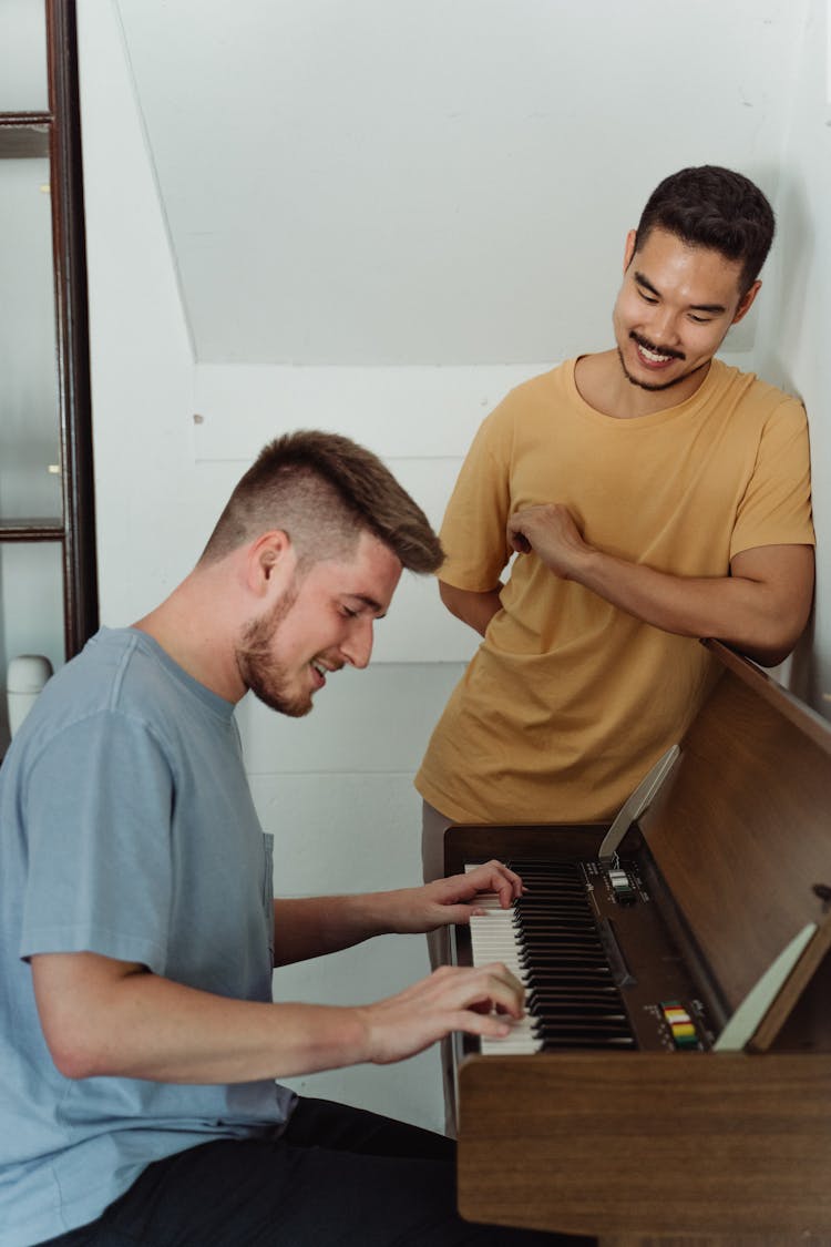 Man Fondly Watching The Person Playing Piano