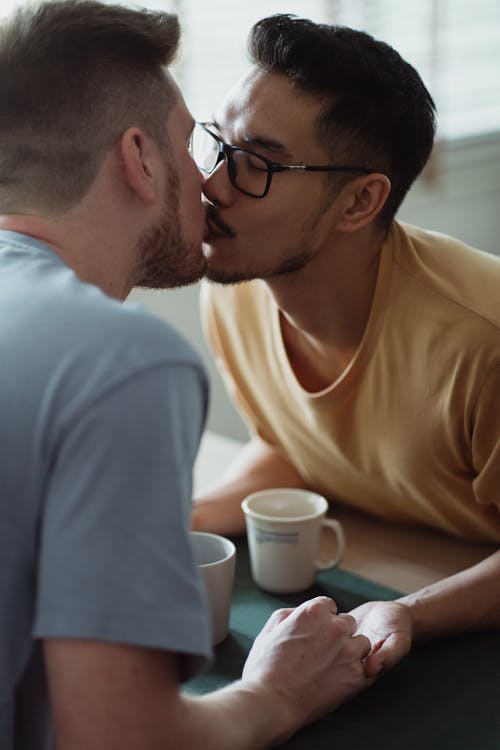 Free Two Men Kissing and Holding Hands Stock Photo