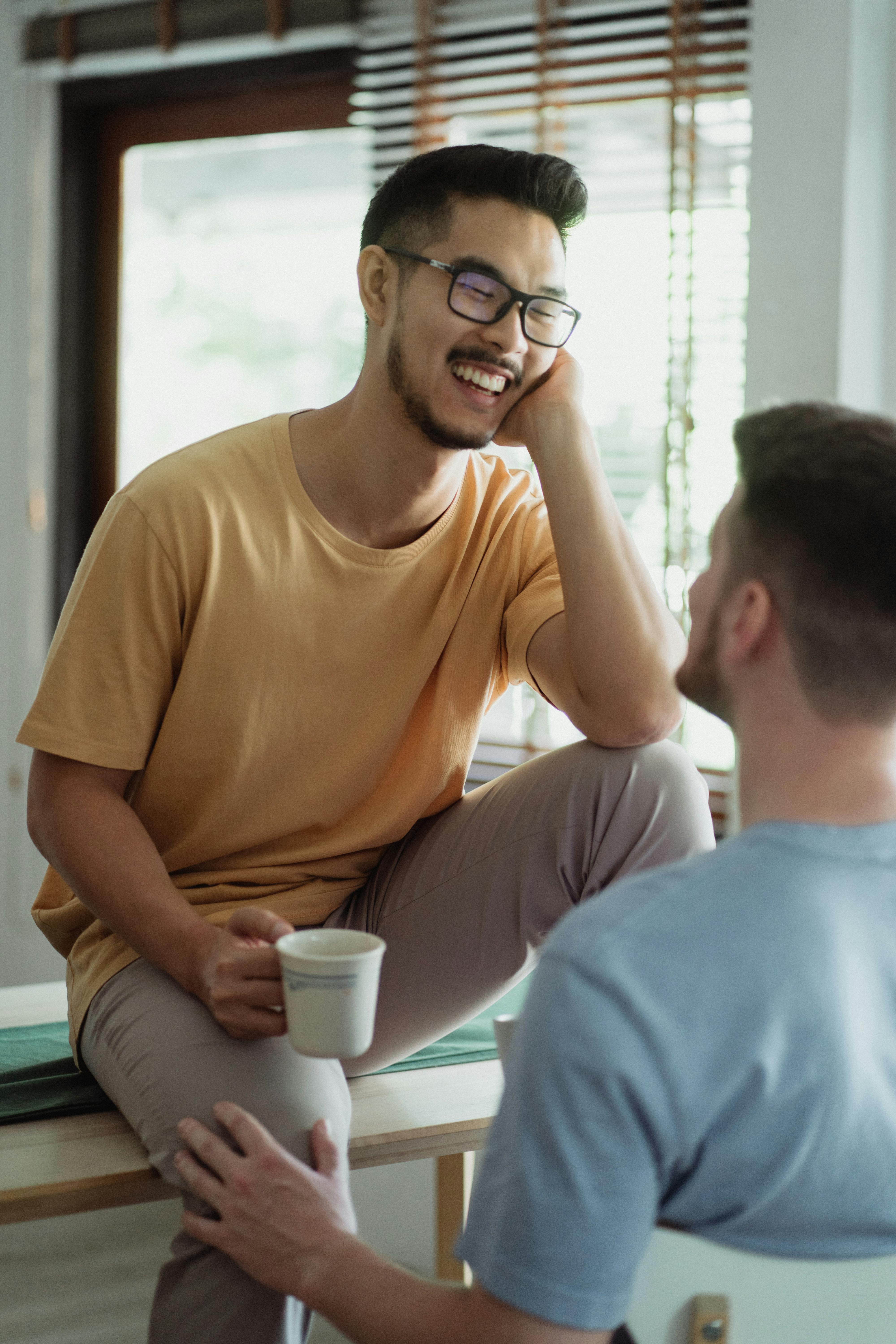 man sitting on a table facing a man sitting