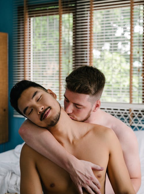 Free Man Kissing Another Man on the Neck Stock Photo