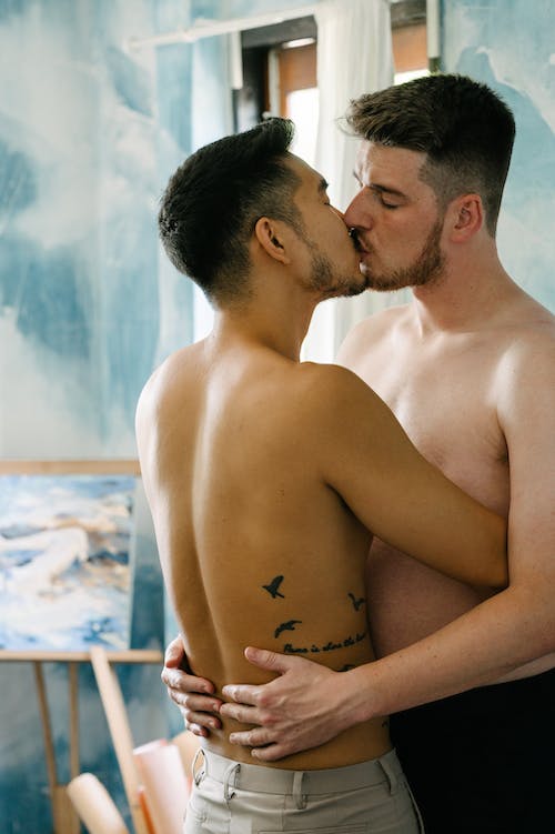 Two Shirtless Men Kissing